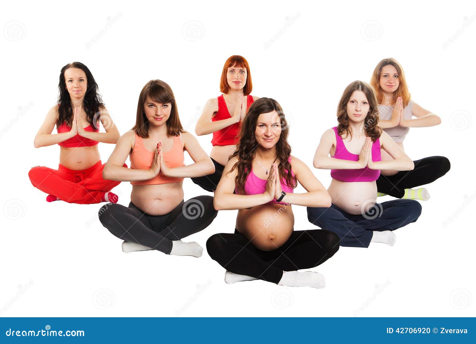 Group Of Six Smiling Pregnant Women Doing Yoga Stock