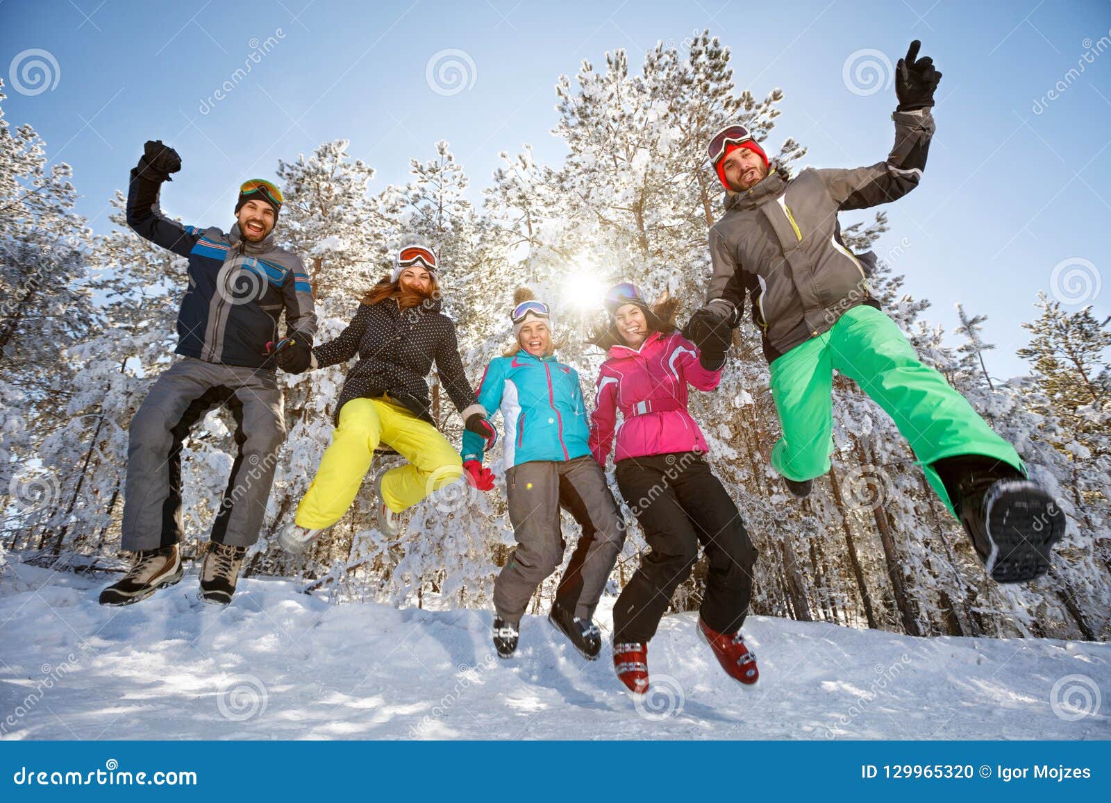 Group of skiers in jump stock photo. Image of smiling - 129965320