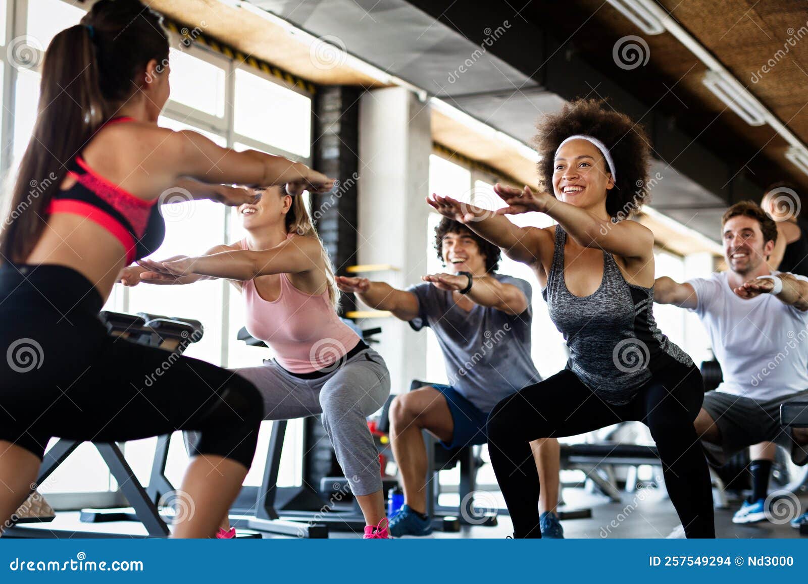 Group of Fit People Working Out in a Gym. Multiracial Friends