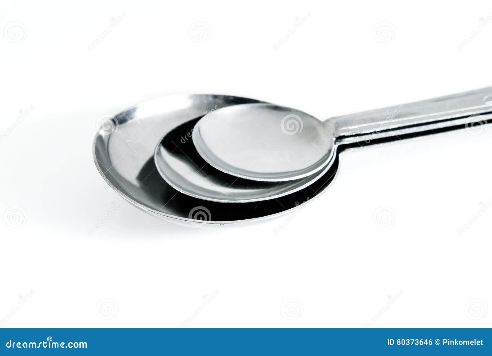 Group of Steel Measuring Spoons , Kitchen Equipment on White Ba Stock