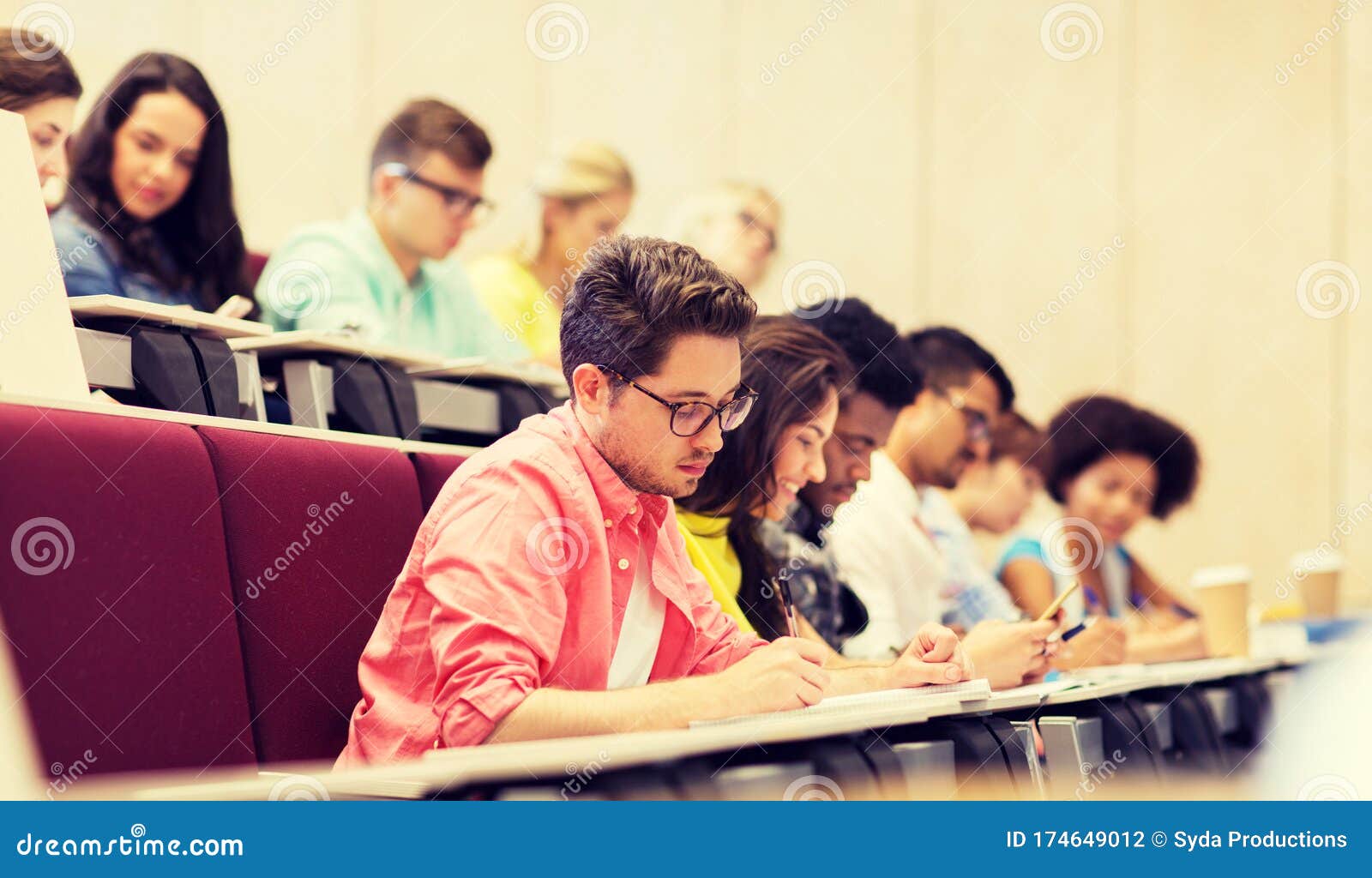 group of students with notebooks in lecture hall