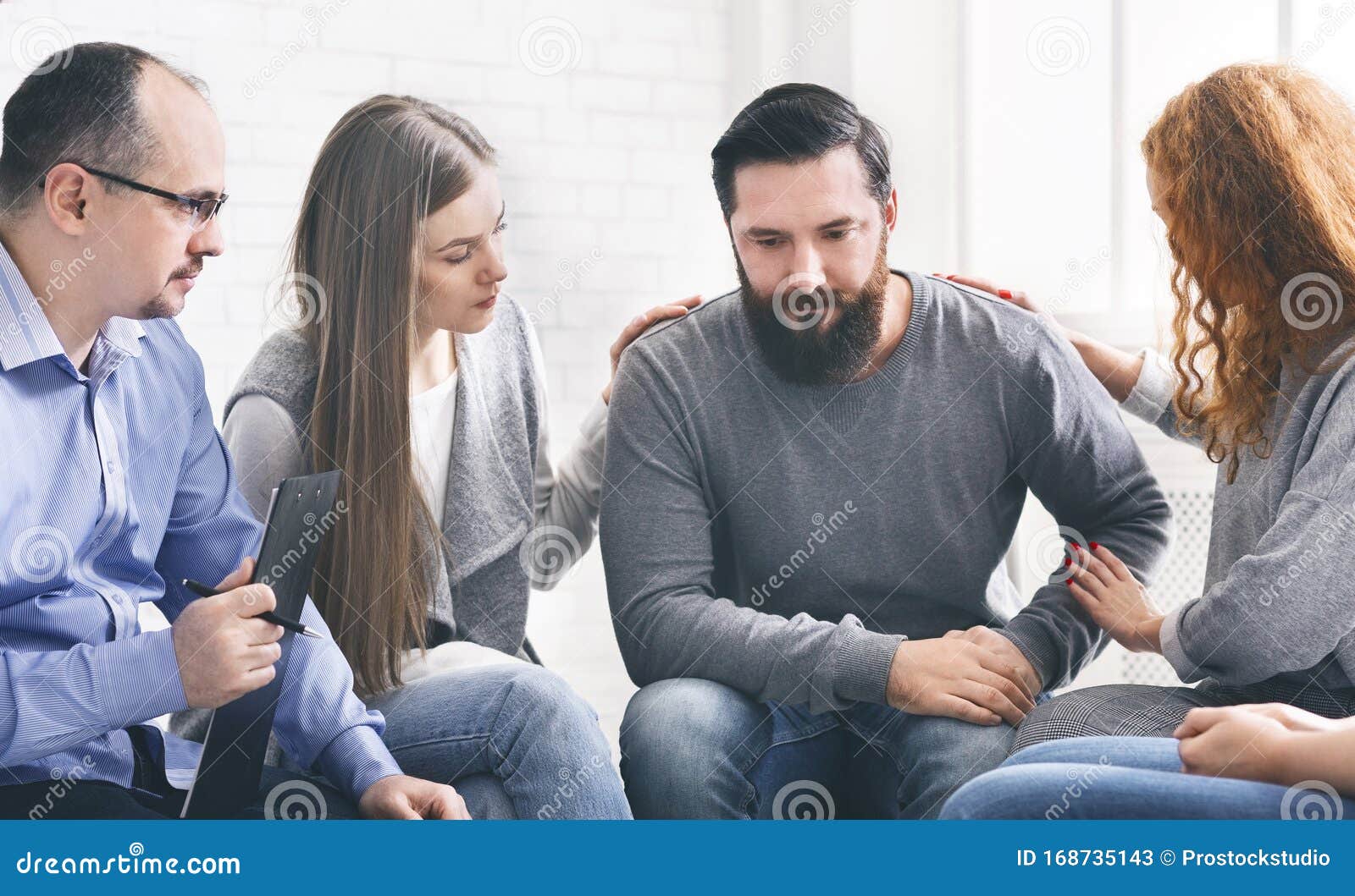 group supporting depressed man with alcoholism problem