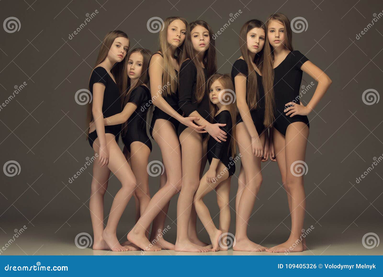 the group of teen girls posing at white studio