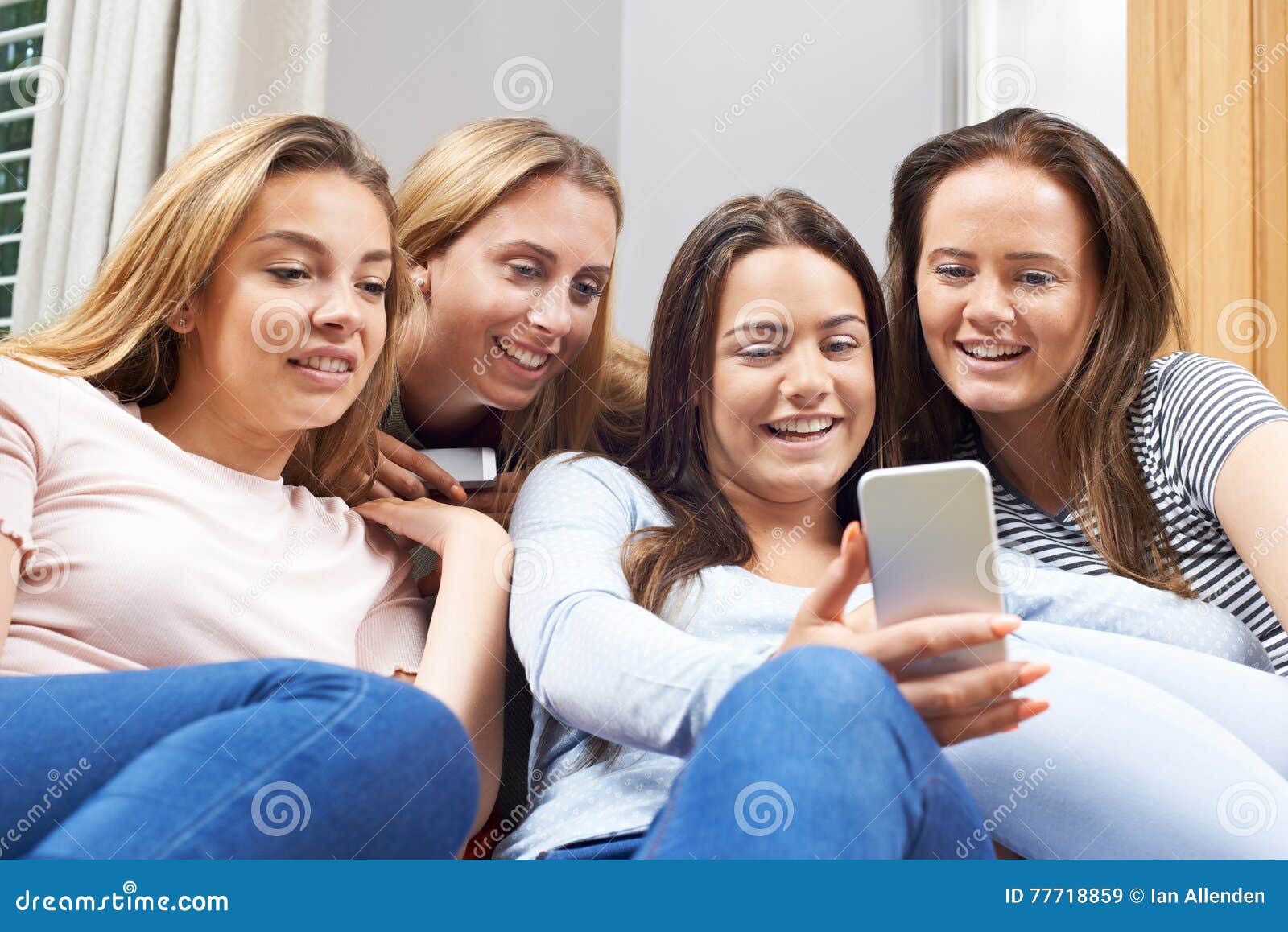 Group of Teenage Girls Reading Text Message on Mobile Phone Stock Image ...