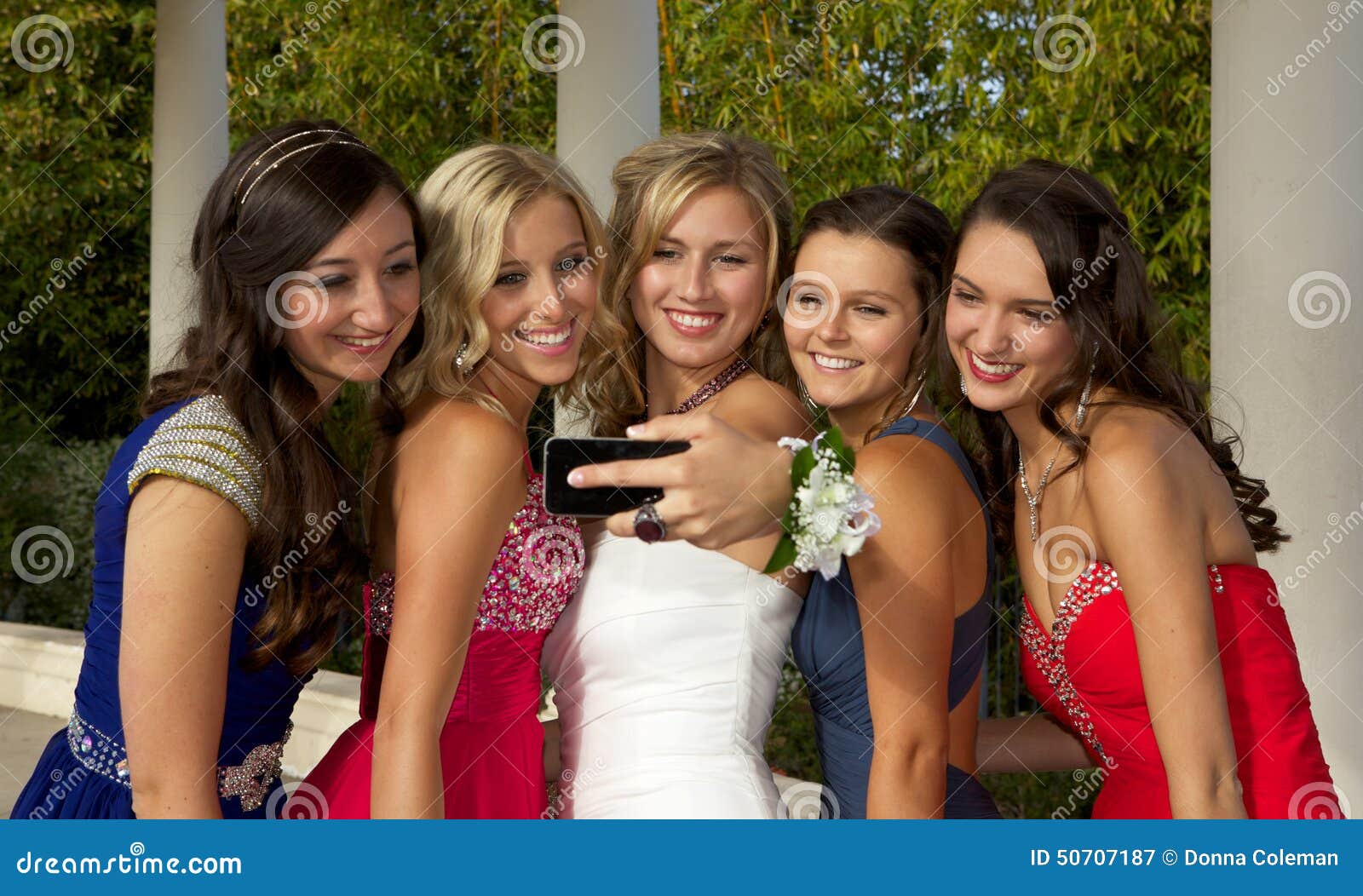 a group of teenage prom girls taking a selfie