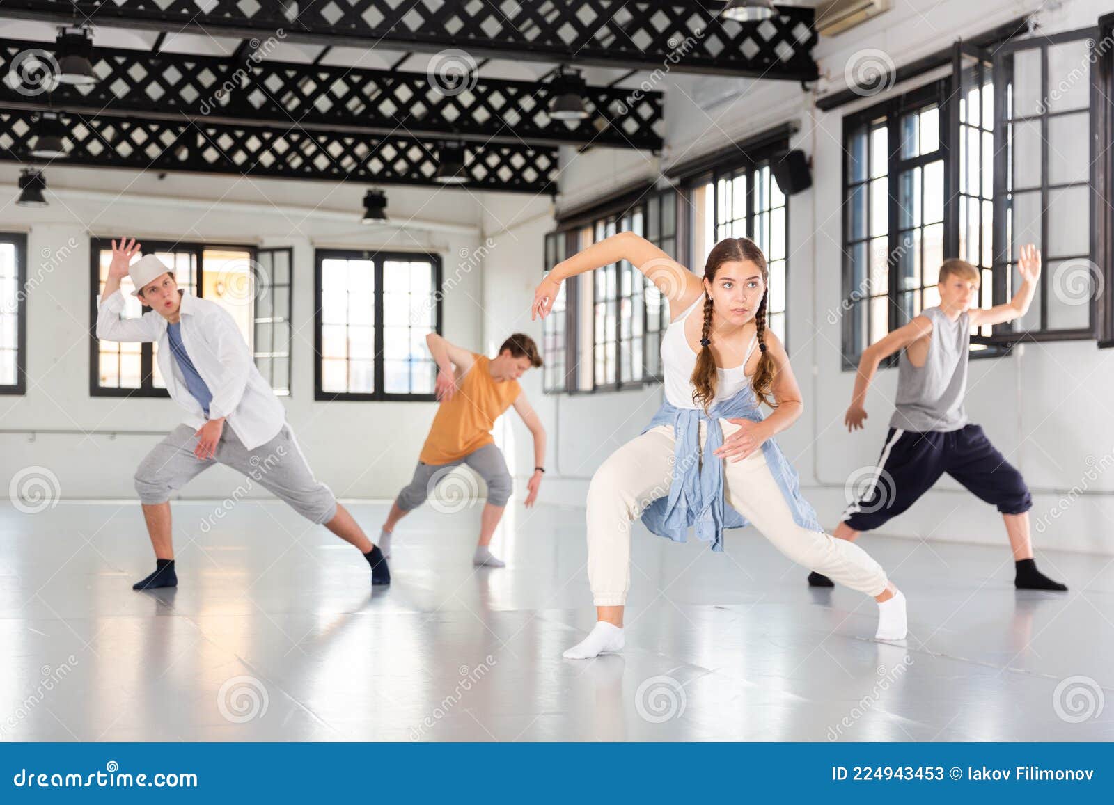 teenagers training contemporary dance at studio