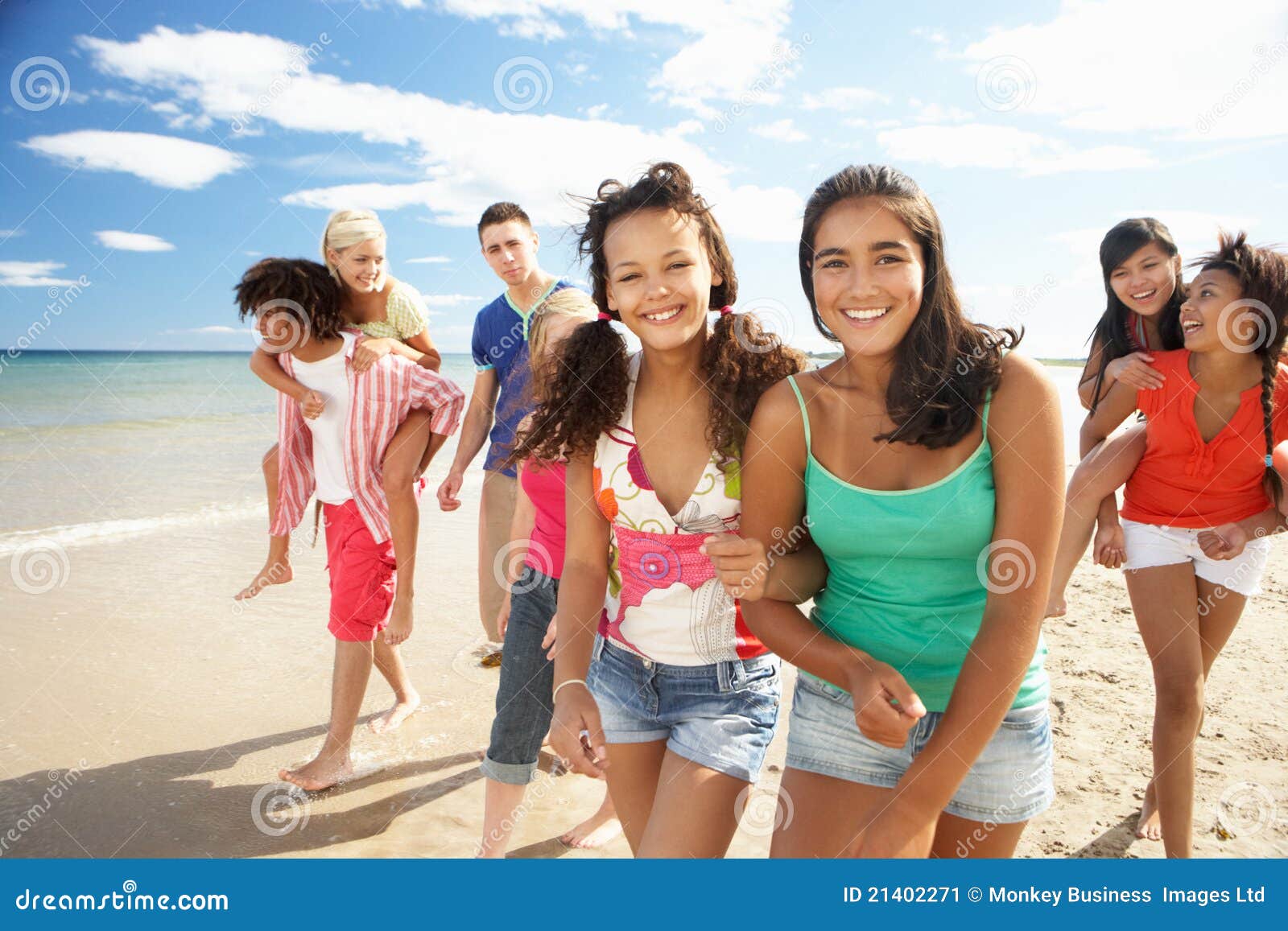 group of teenagers walking along beach