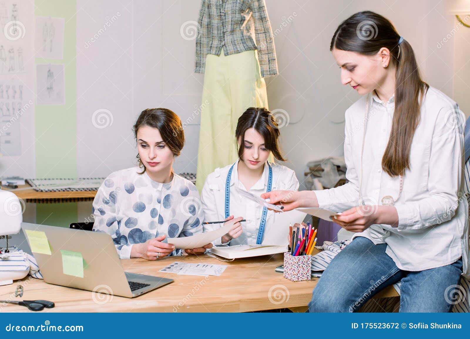 Group of Three Pretty Women Fasion Designers Working with Clothes ...