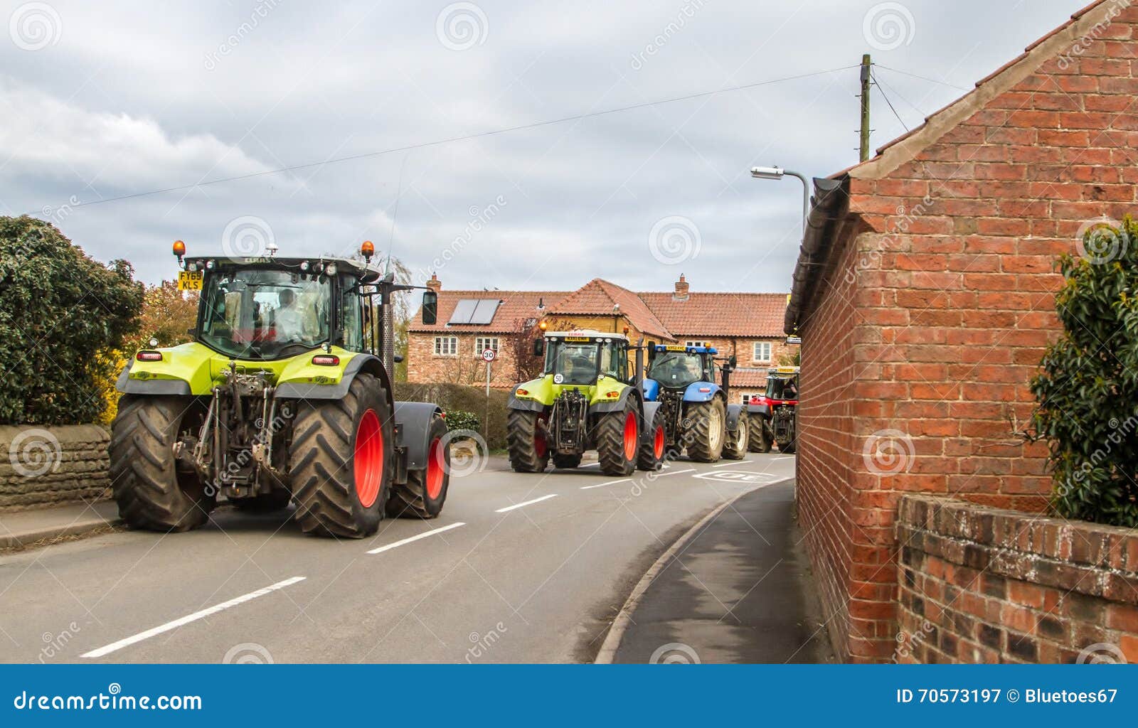 A Group of Tractors Going through a Village Town Editorial Photography