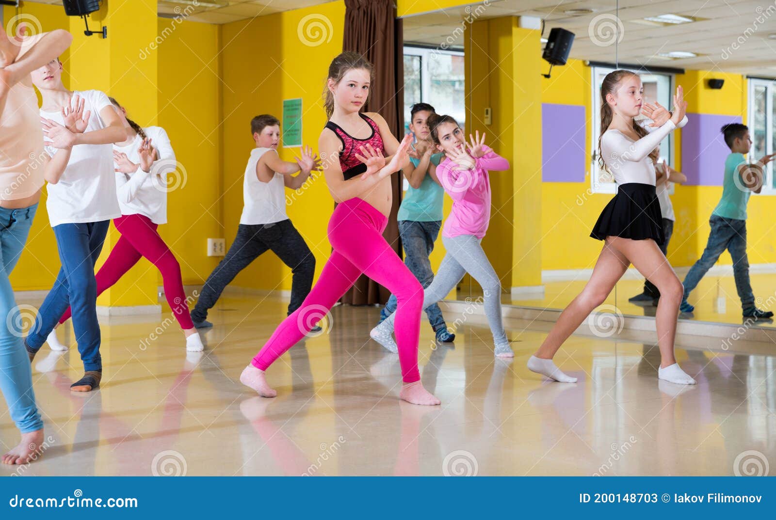 tweens exercising with coach in choreography class