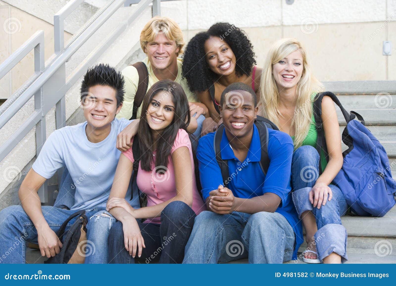 group of university students sitting on steps
