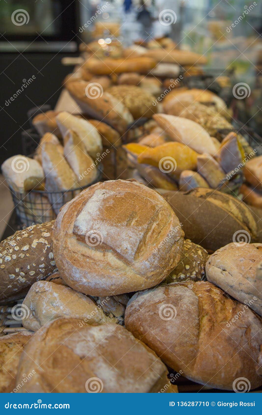 Group of Various Types of Bread, and Loaves Inside a Bakery Stock Photo