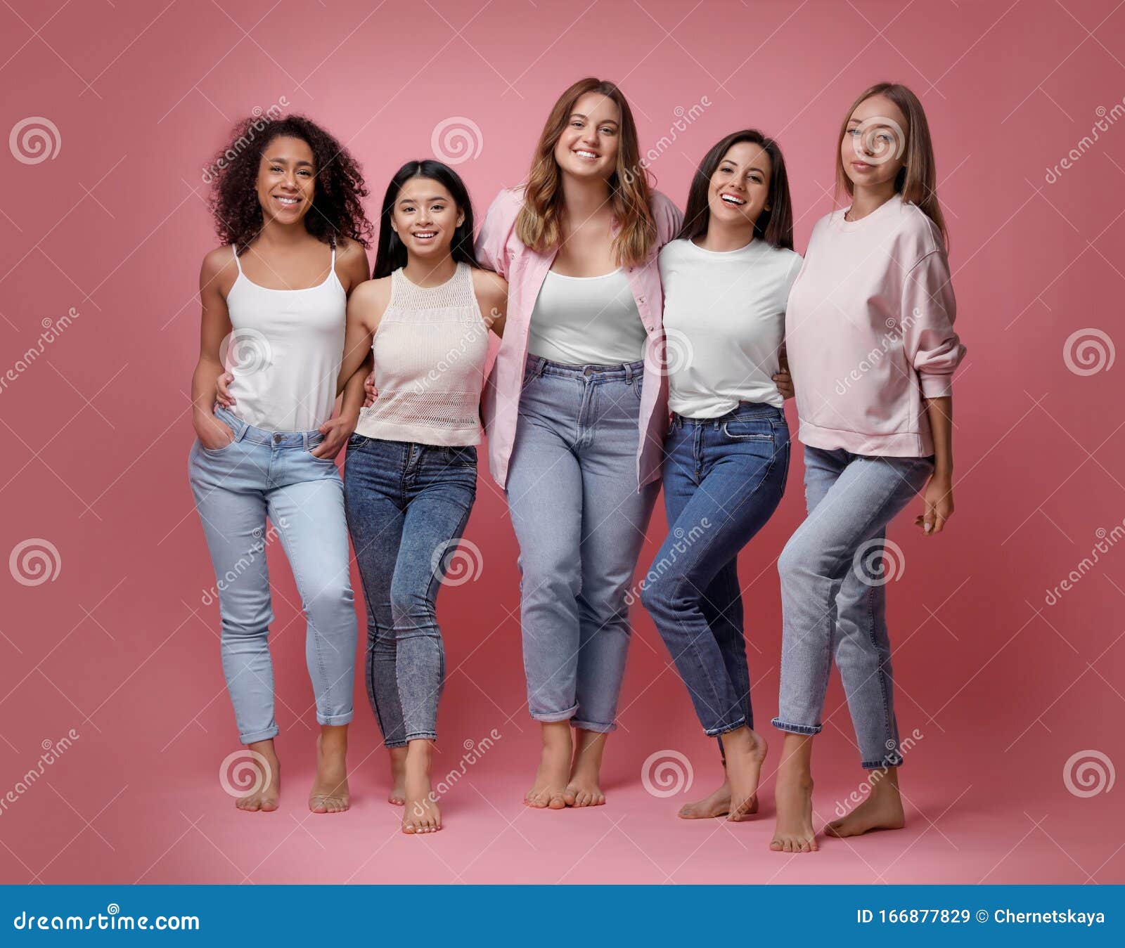 Three glad diverse millennial women in undergarments sit on floor, enjoy  body positivity Stock Photo by Prostock-studio