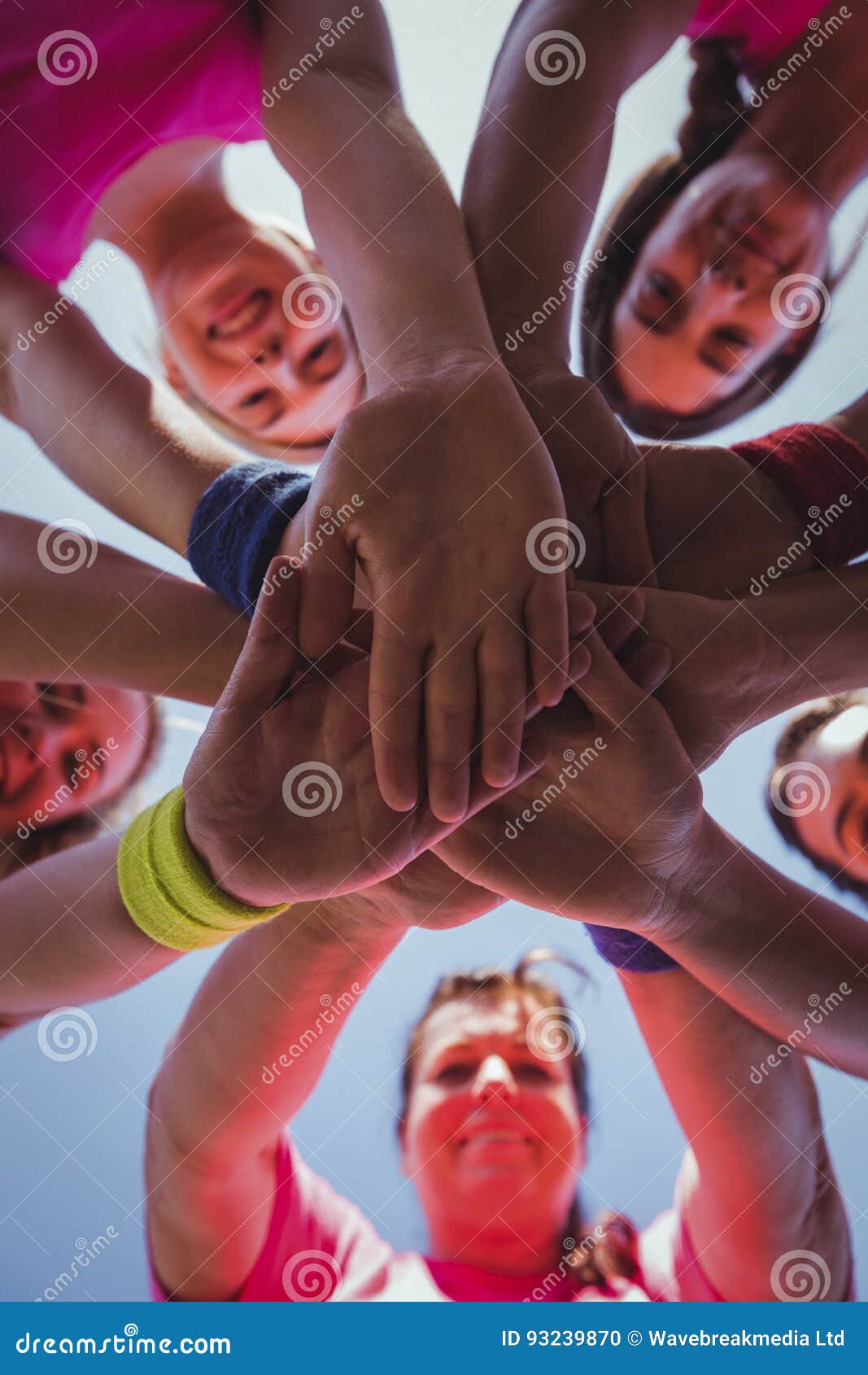 group of women forming hand stack in the boot camp
