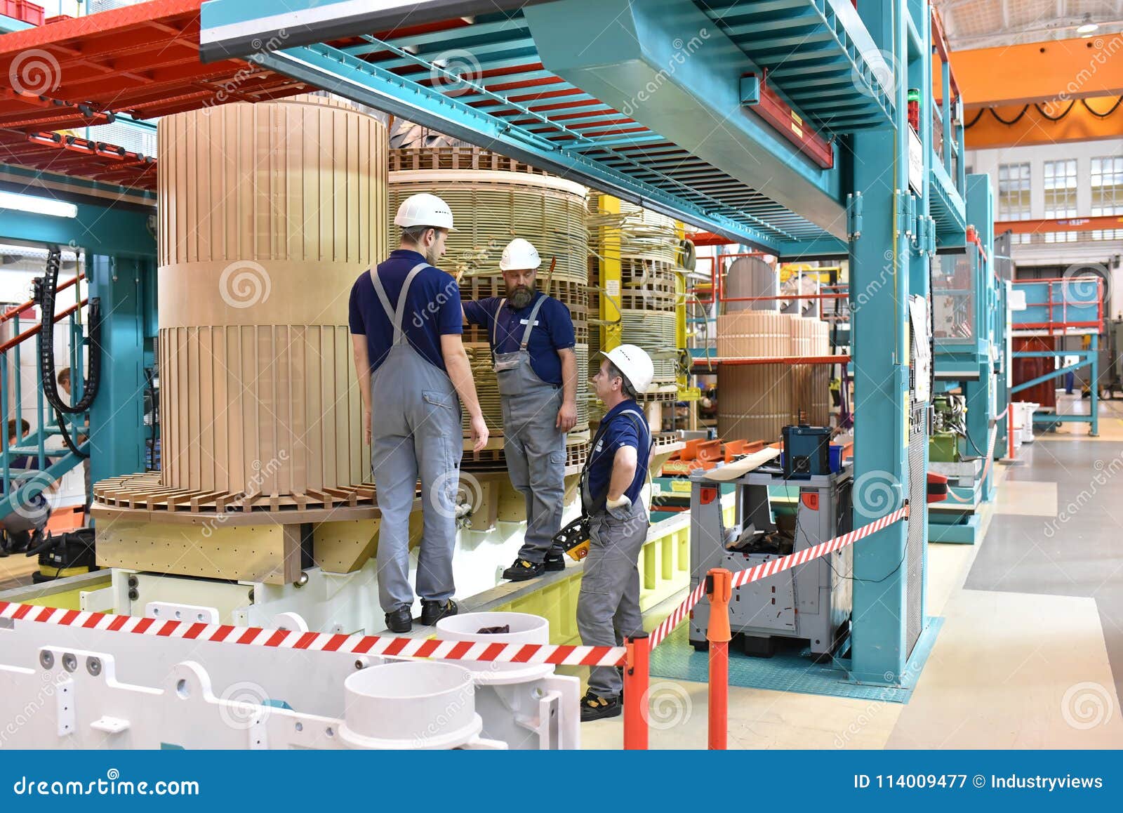 group worker assembles a transformer in mechanical engineering -