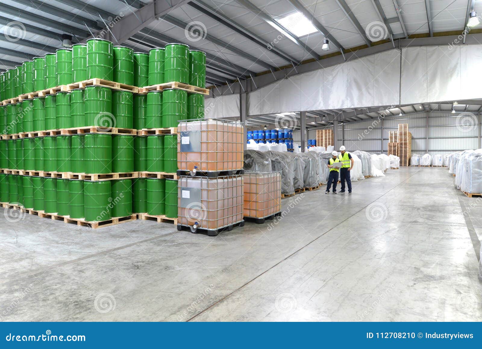 Group of Workers in the Logistics Industry Work in a Warehouse W Stock