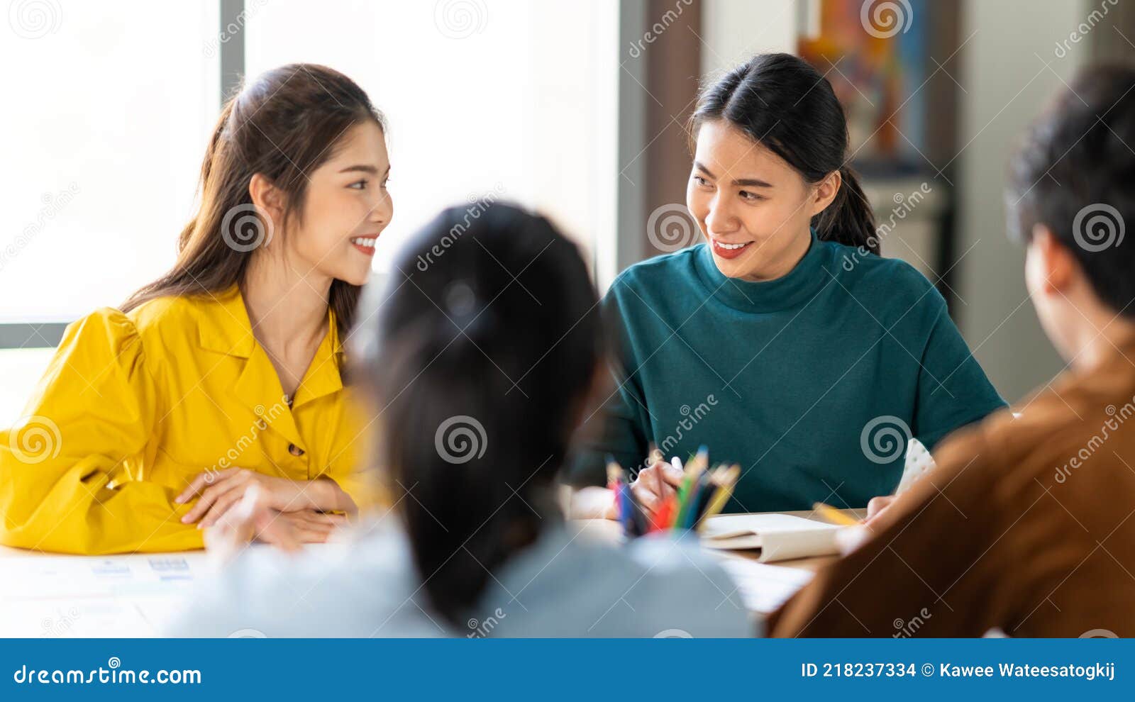 group of young asian business people or creative team in brainstorm discussion meeting in office. female coworker lead team talk