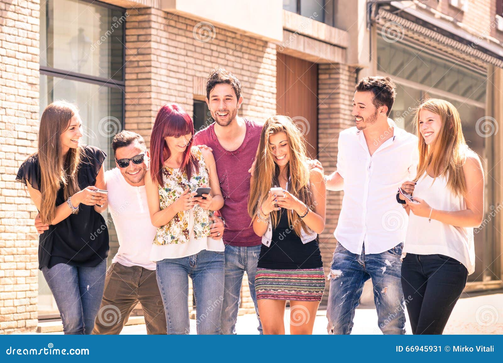 group of young best friends having fun together walking in town