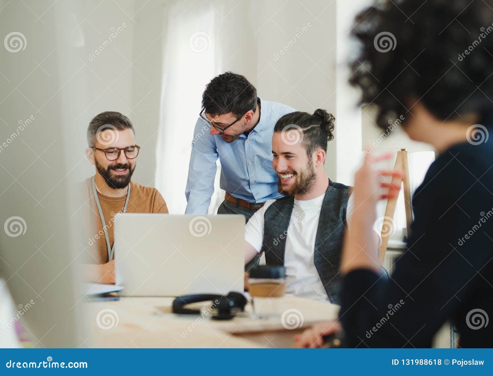Group of Young Businesspeople with Laptop Working Together in a Modern ...