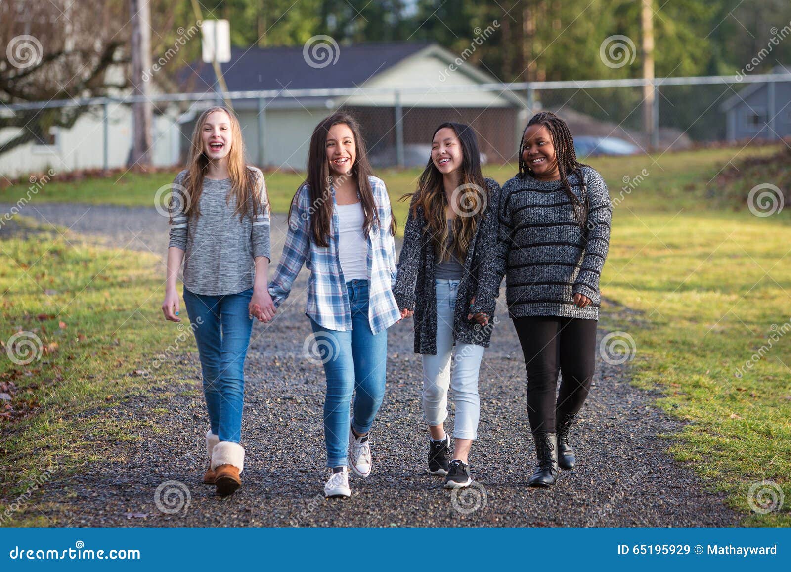 Group of Young Girls Holding Hands and Laughing while Walking on ...