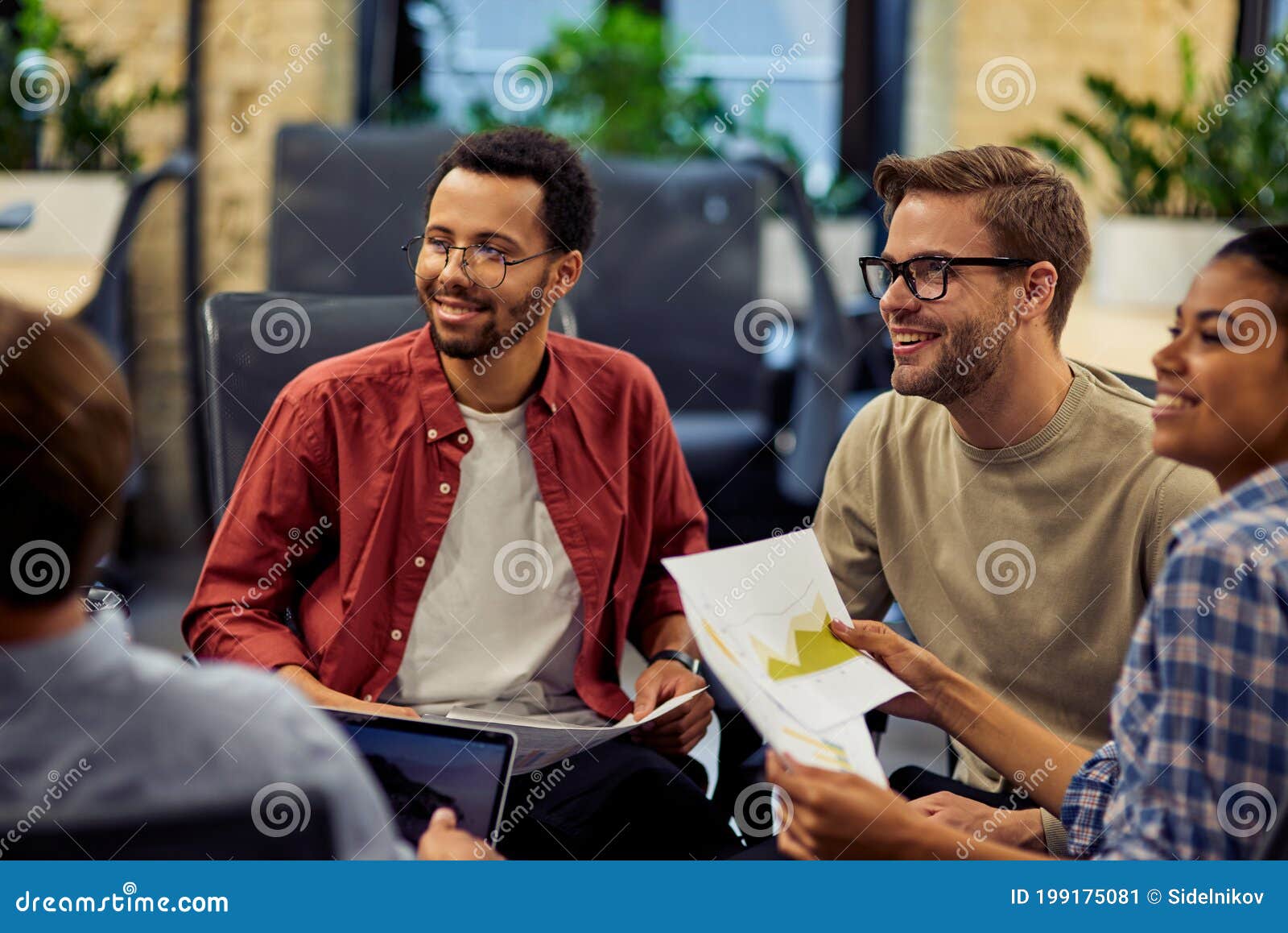 group of young and happy diverse multi ethnic business people analyzing project results while working together in modern