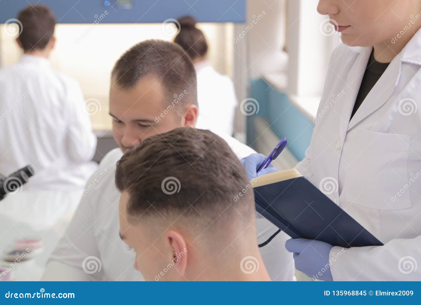 Group of Young Laboratory Scientists Working at Lab with Test Tu Stock