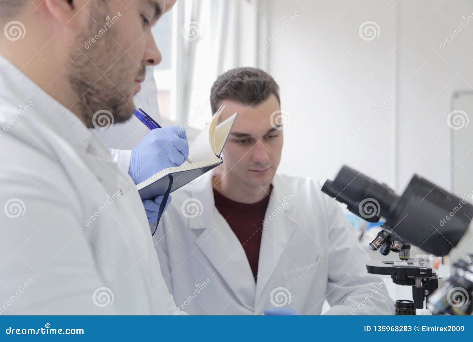 group of young laboratory scientists working at lab with test tu