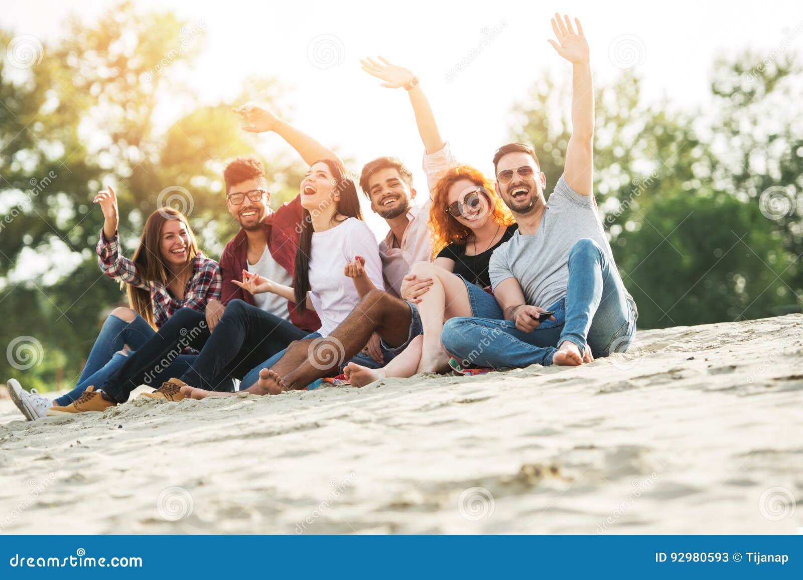 group of young people having fun outdoors on the beach