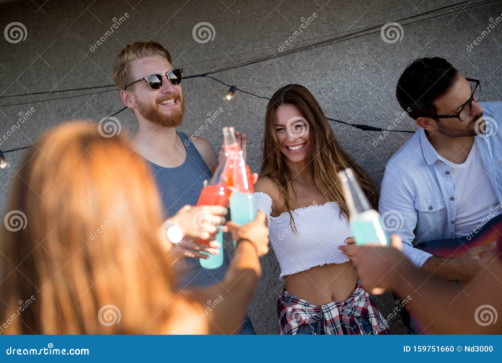 Group of Young People Having Fun at a Summertime Party, at Sunset Stock ...