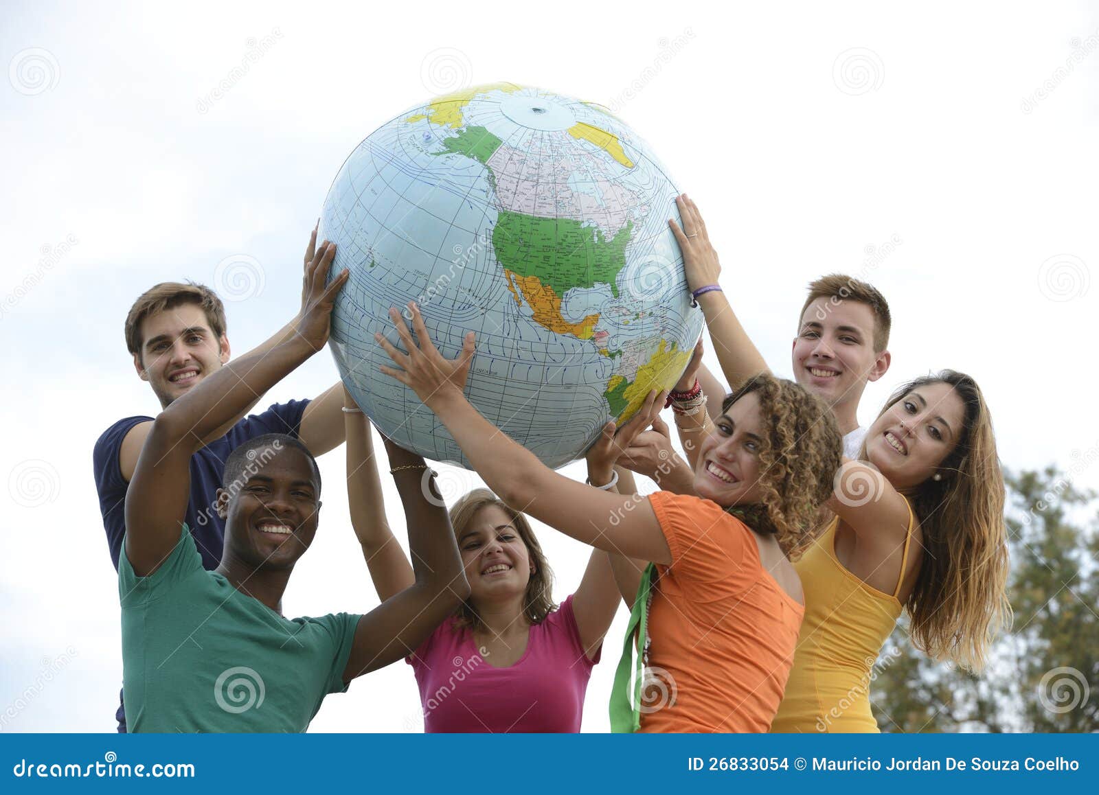 group of young people holding a globe earth