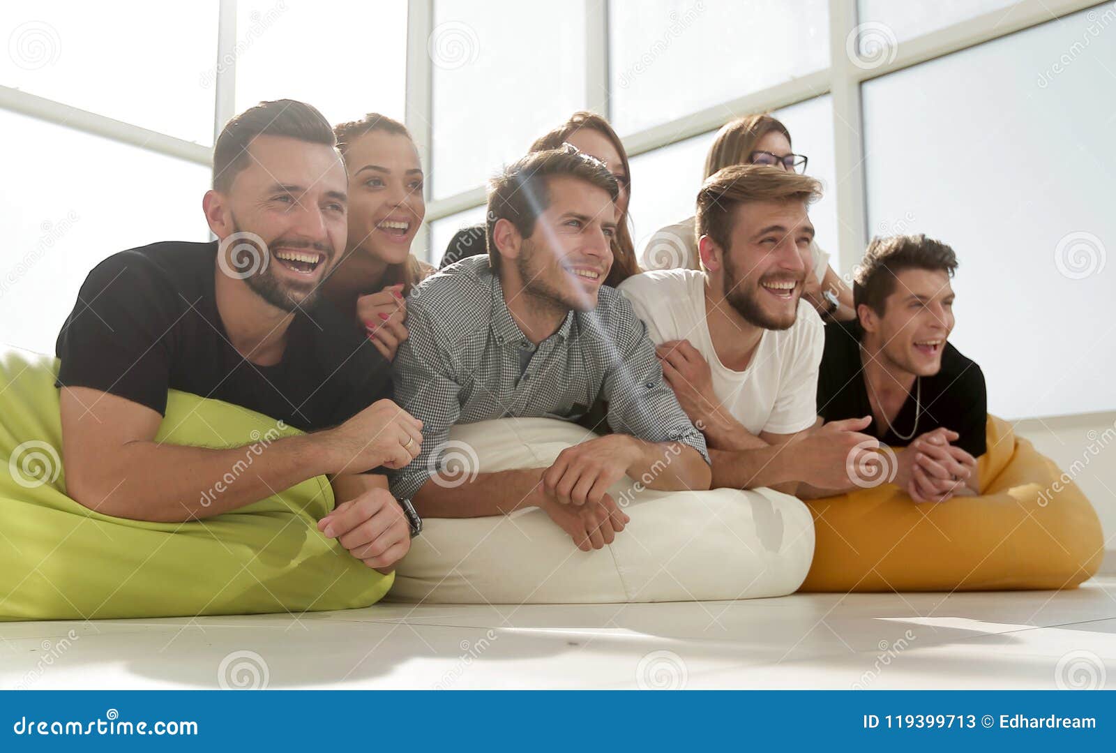 Group Of Young People Lying On The Floor And Smiling Stock Image