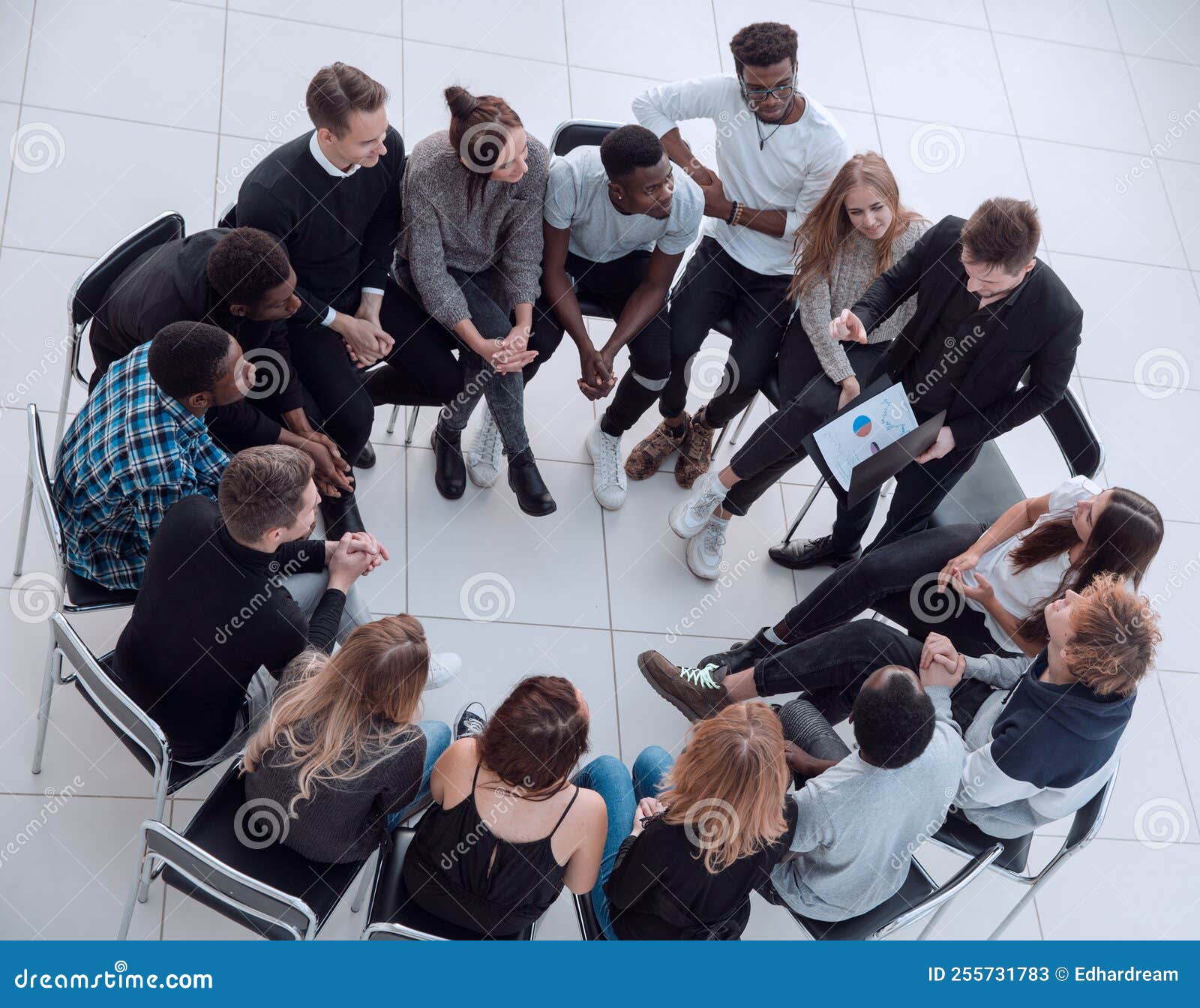 A Group of Young People Sit Around a Discussion Stock Image - Image of