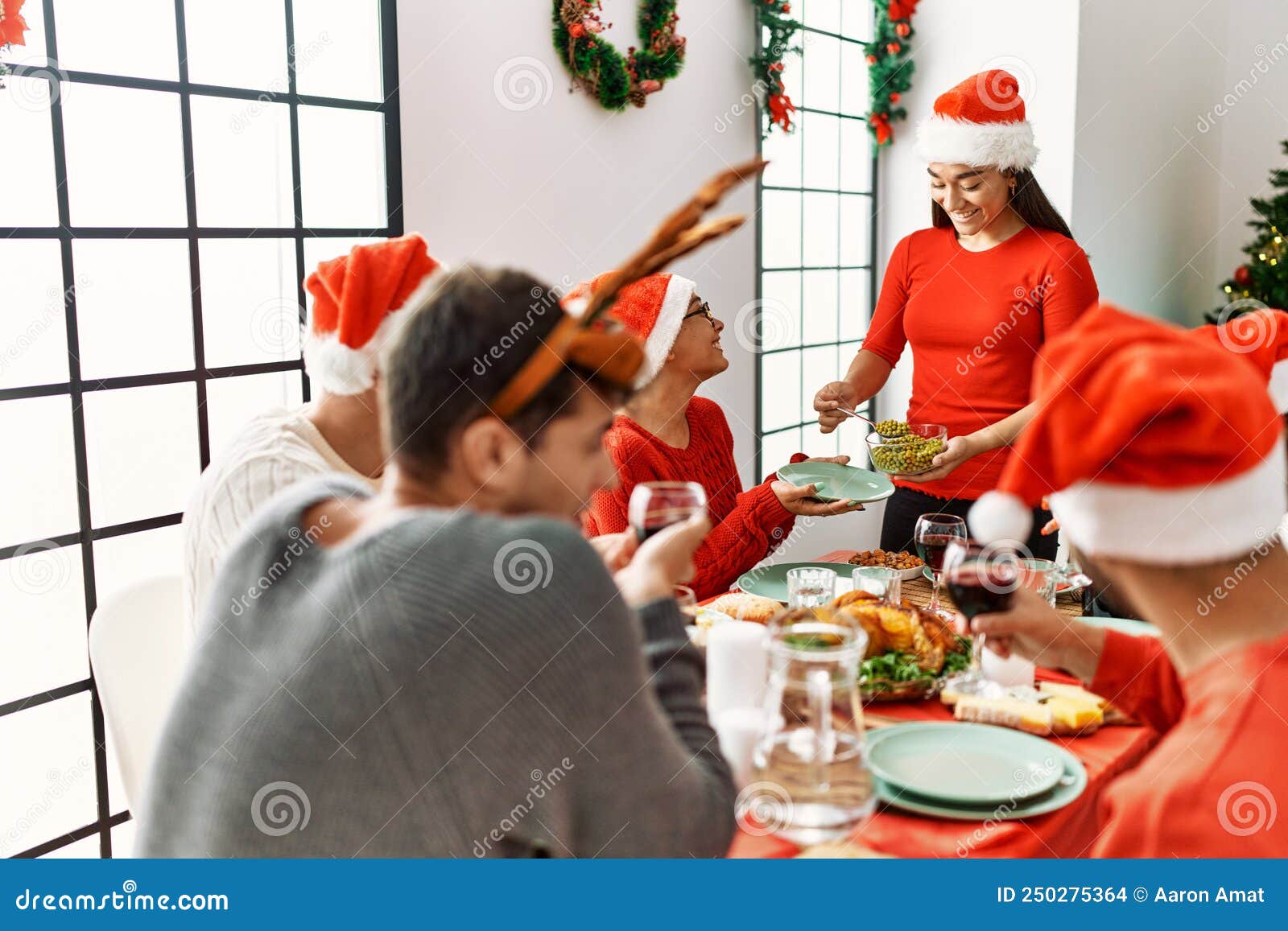 Group of Young People Smiling Happy Having Christmas Dinner at Home