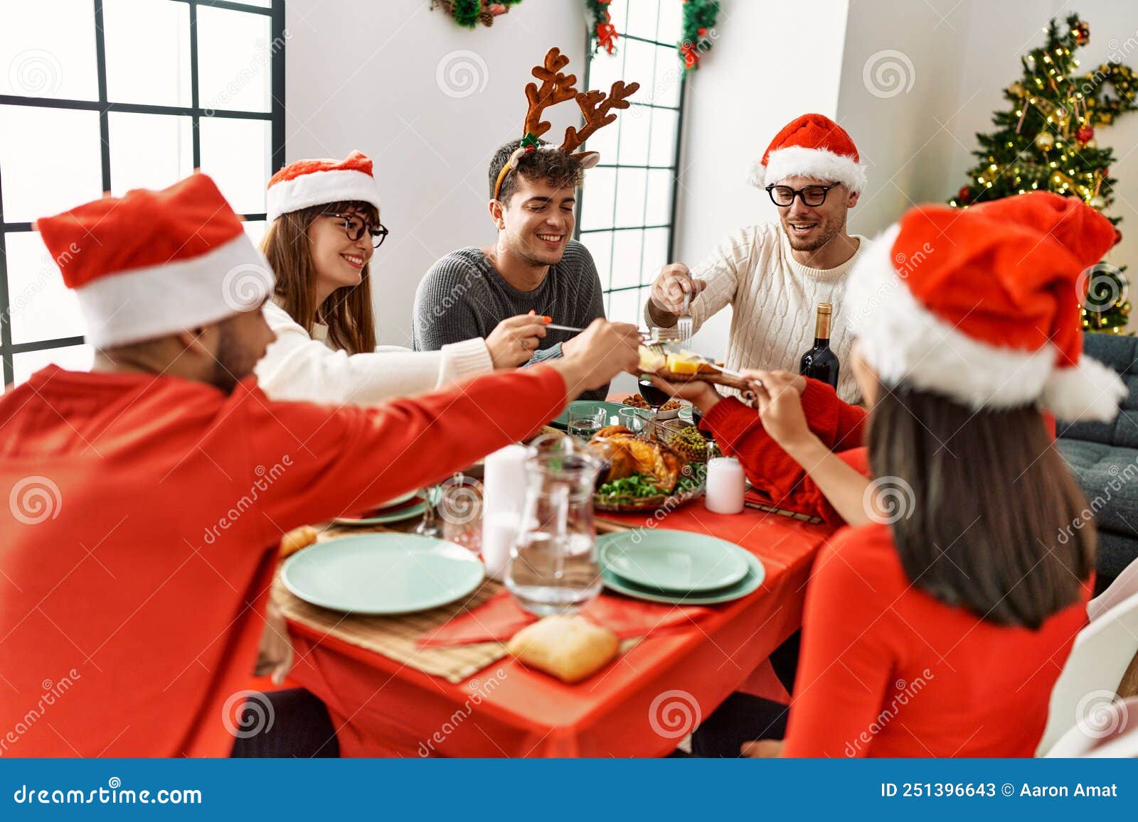 Group of Young People Smiling Happy Having Christmas Dinner at Home