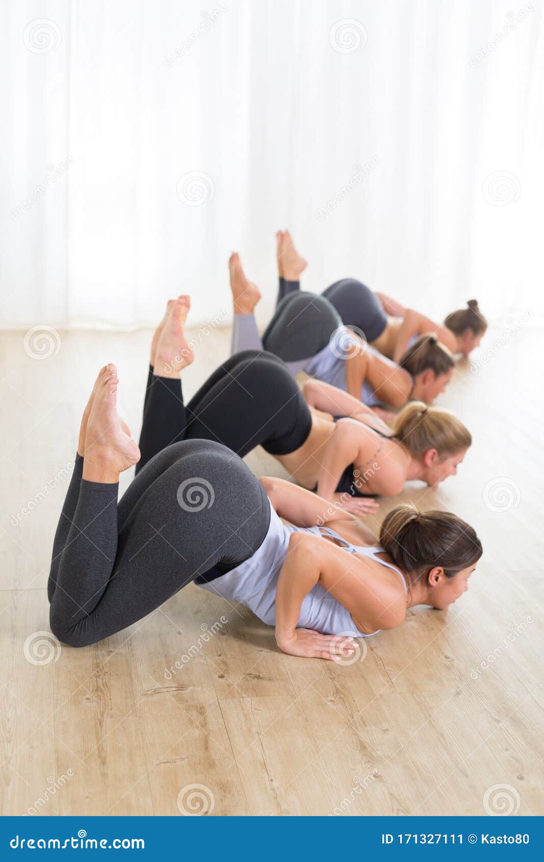 Group of Young Sporty Women in Yoga Studio, Practicing Yoga Lesson with  Instructor, Forming a Line in Front Bent Stock Image - Image of meditating,  health: 171327111