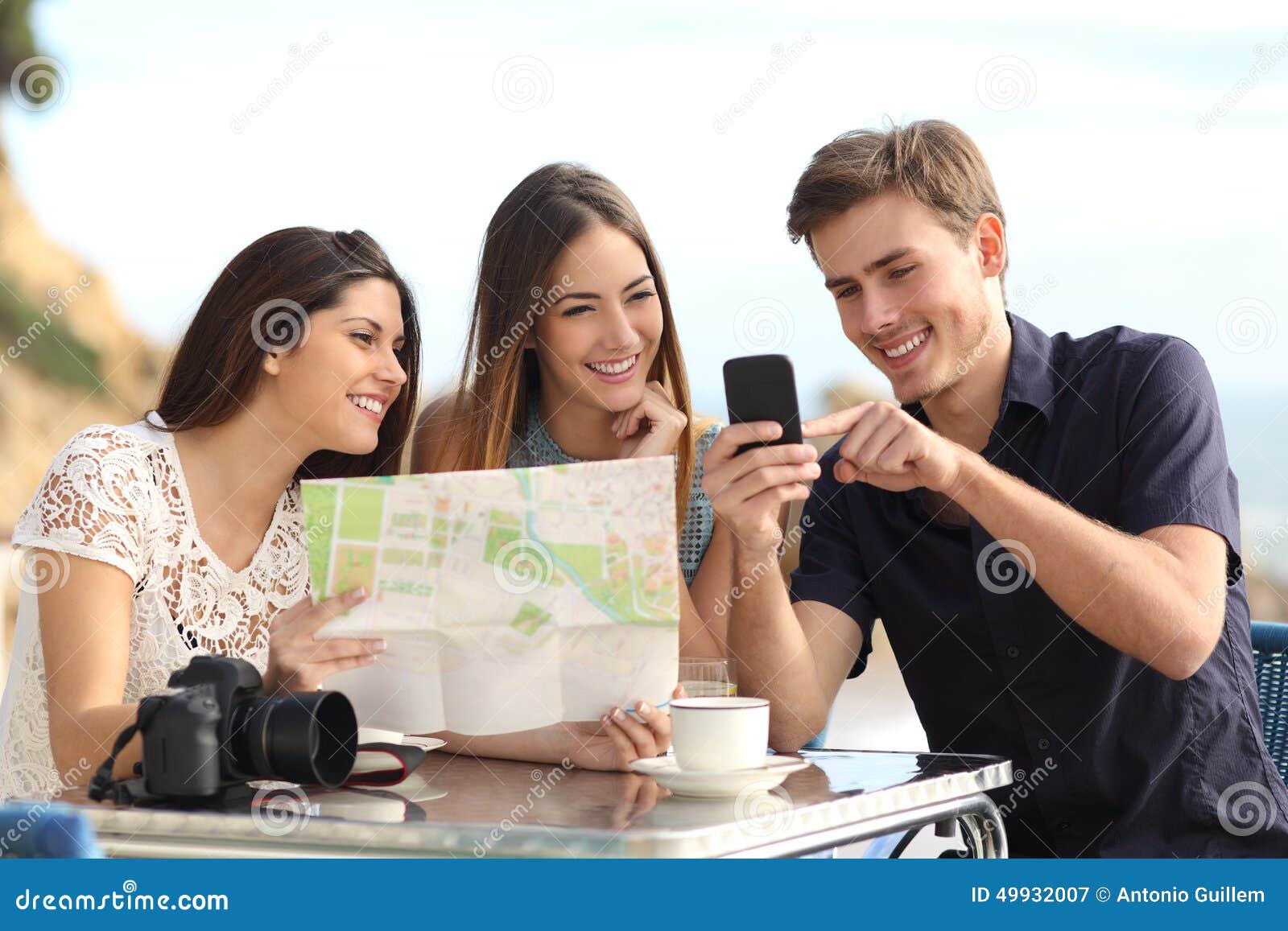 group of young tourist friends consulting gps map in a smart phone