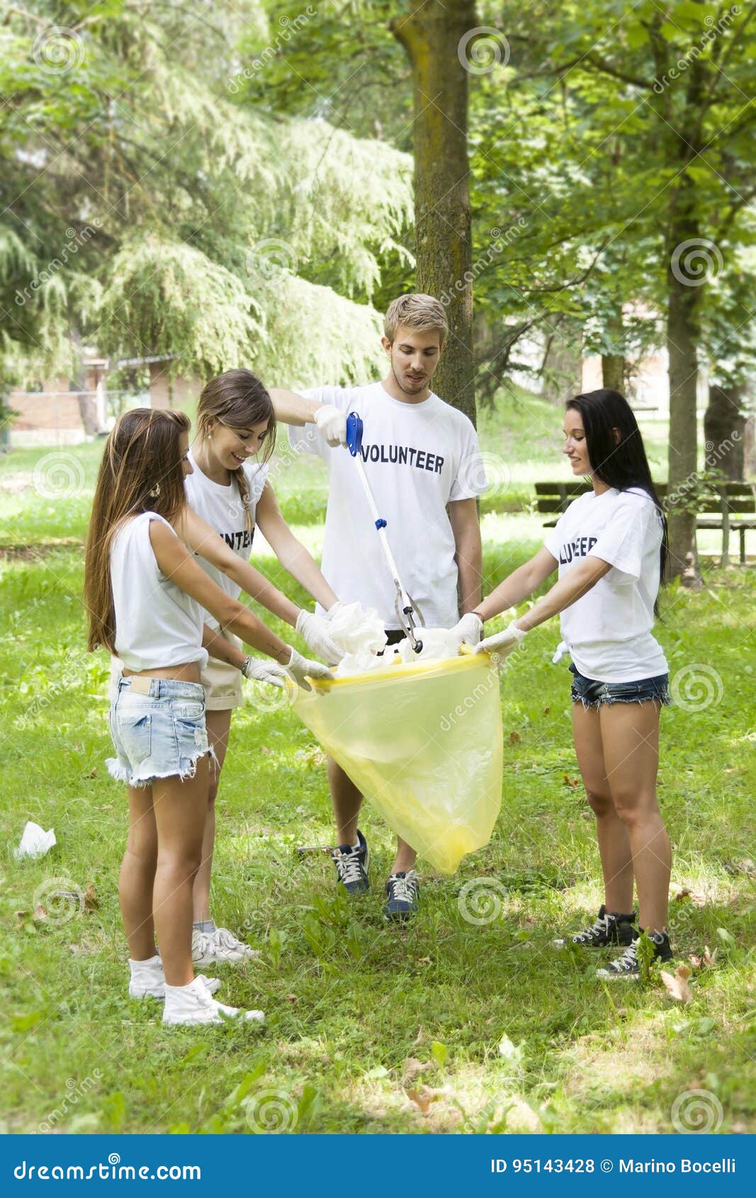 Group of Young Volunteers Picking Up Litter in the Park Stock Photo