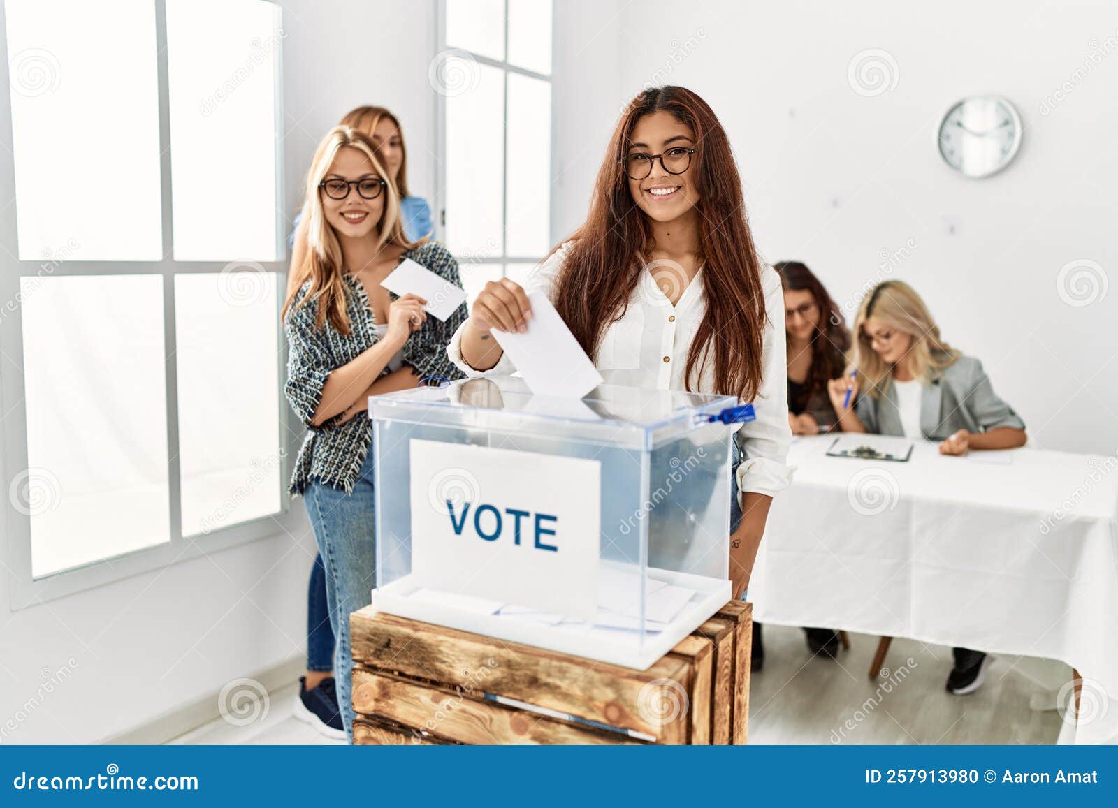 Group of Young Voter Woman Smiling Happy Putting Vote in Voting Box at Group of Young Voter Woman Smiling Happy Putting Vote in Voting Box at