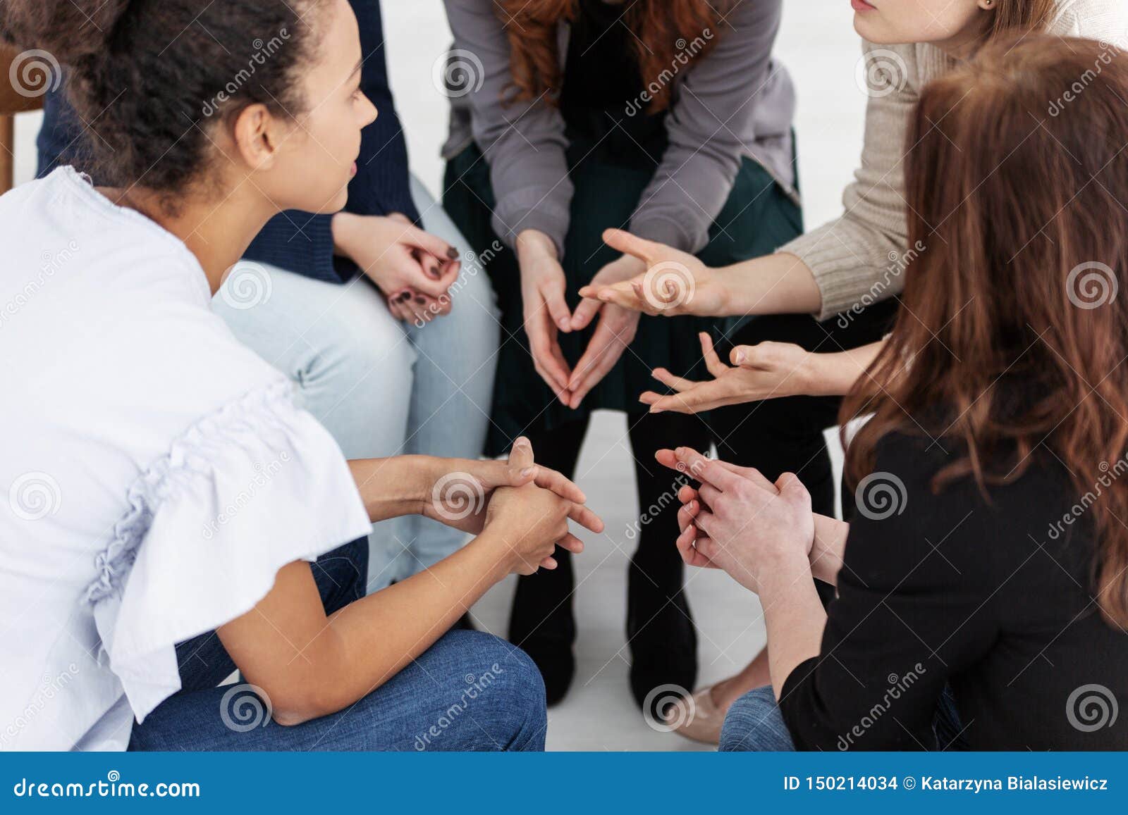 group of young women talking sitting in a circle. psychological support concept