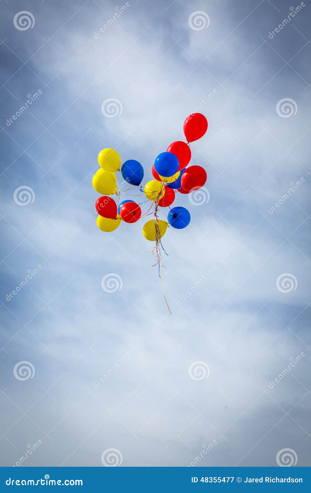 grouping of balloons floating away
