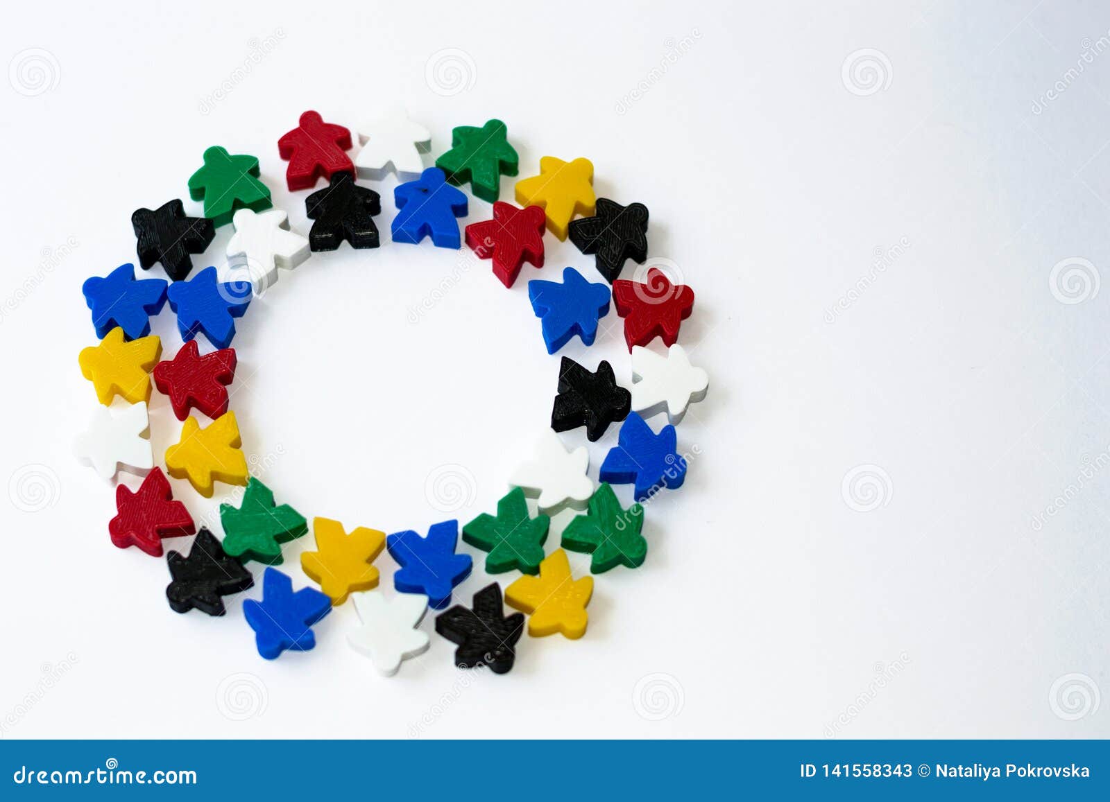 groups of colorful meeples in circle  on white. colorful round frame of game components. small figures of man