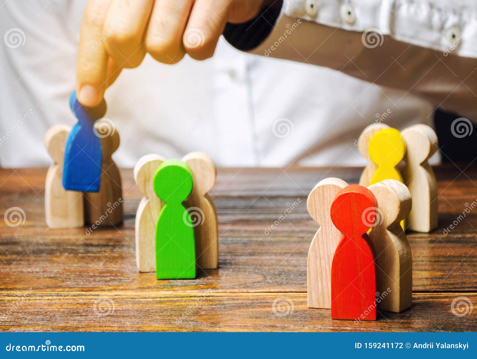 groups of multicolored wooden people and businessman. the concept of market segmentation. target audience, customer care. market