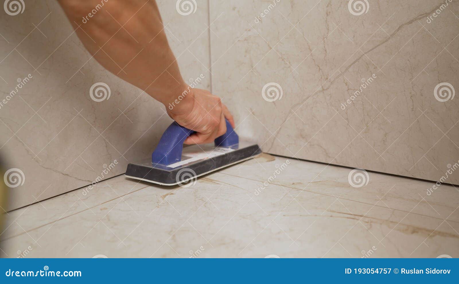 Grouting Ceramic Tiles. Grouting the Floor with Tiles Stock Image