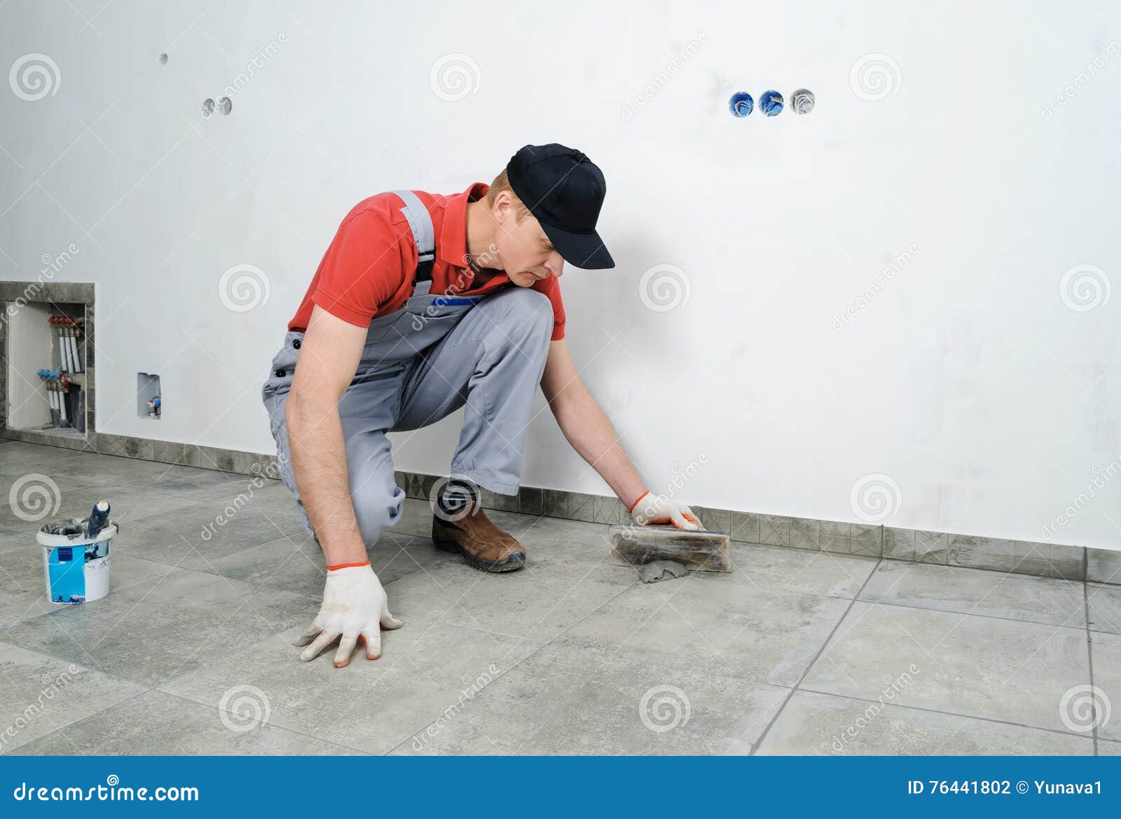 Grouting ceramic tiles. stock photo. Image of repairman 76441802