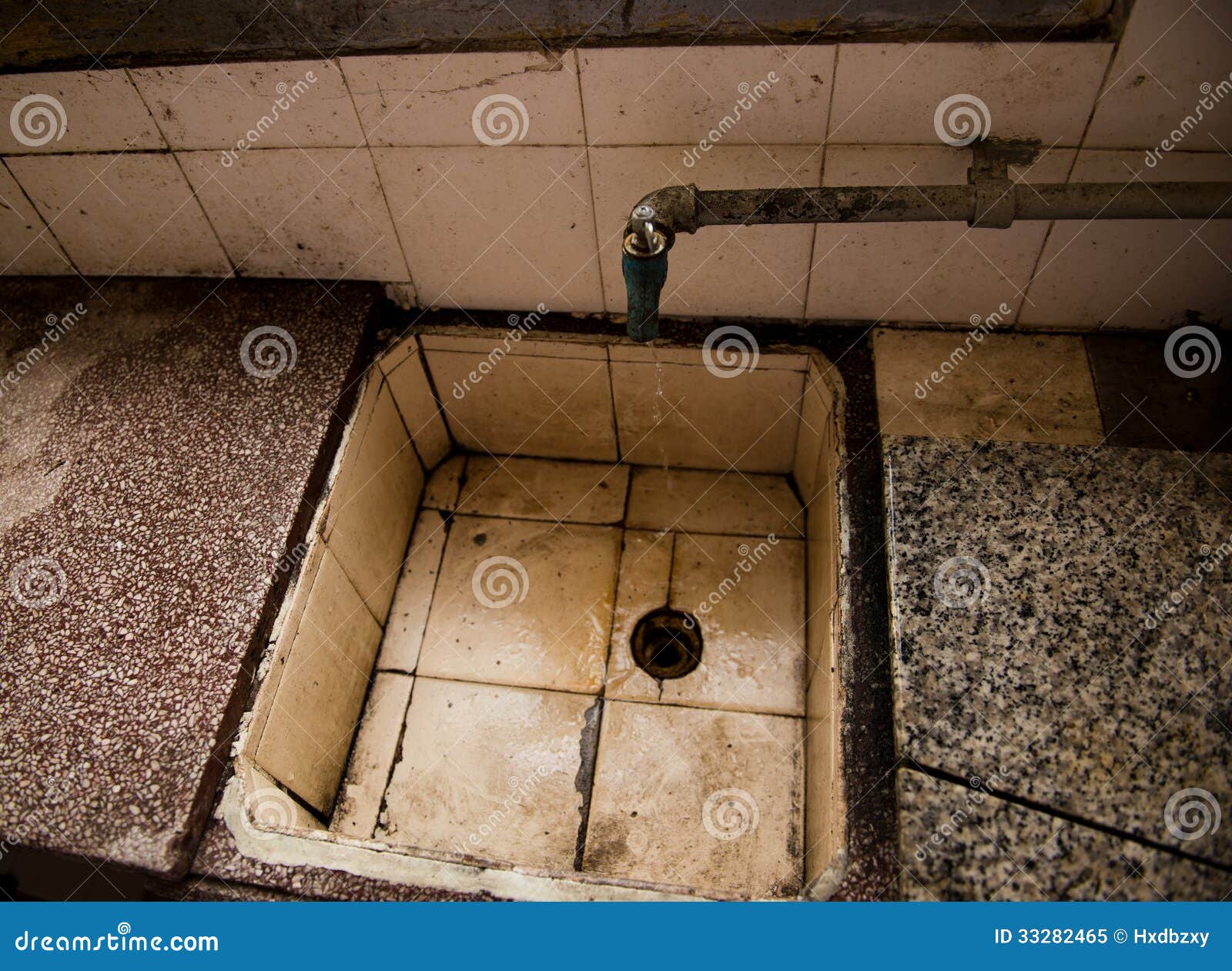 Dirty Sink With Toothbrush And Tap In Dirty Bathroom. RoyaltyFree