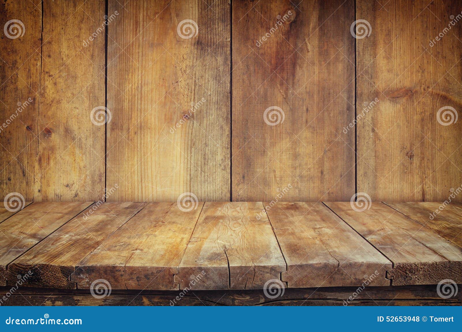 grunge vintage wooden board table in front of old wooden background. ready for product display montages