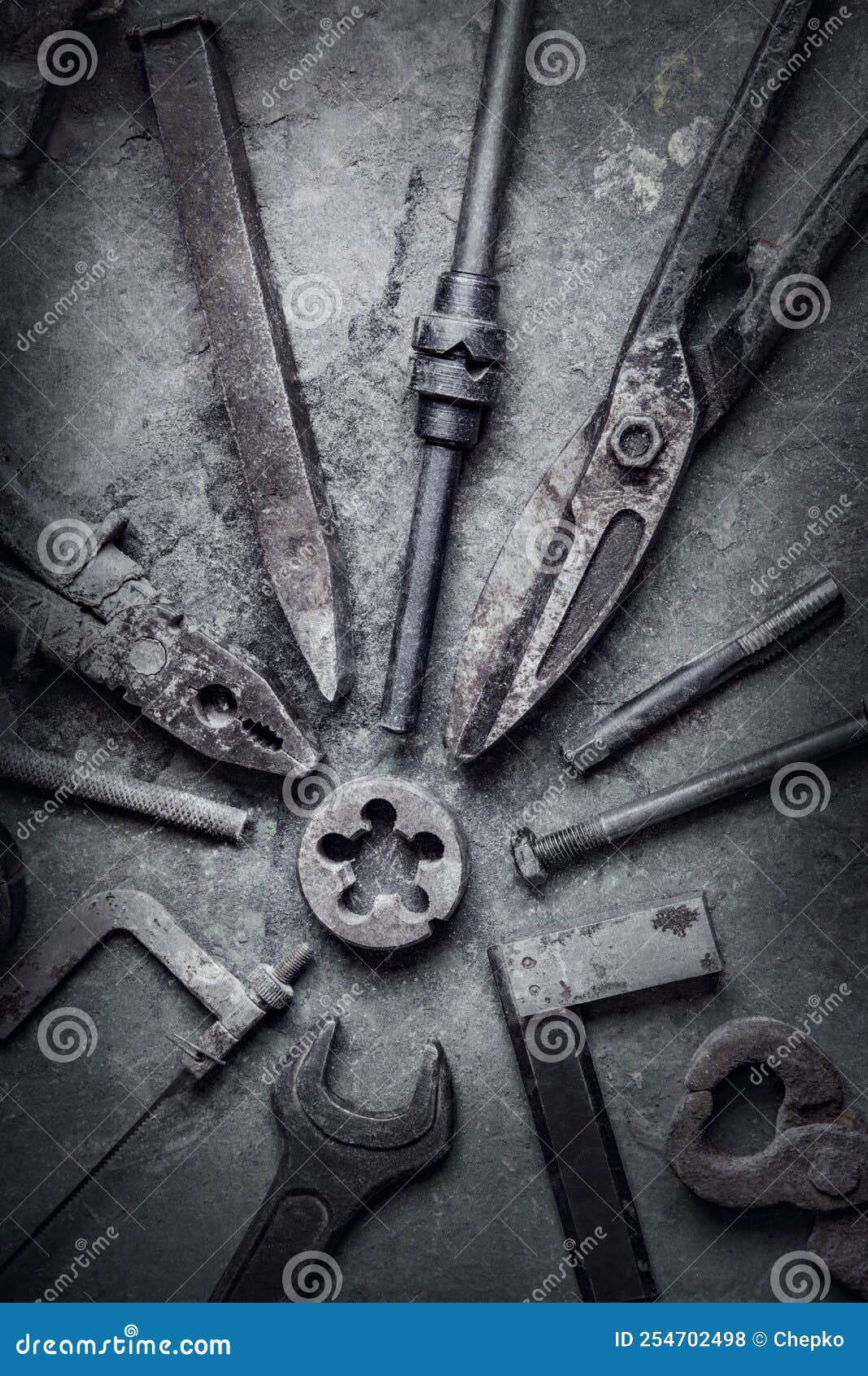 grungy old metalwork tools on old stained table background photo processing cross-process
