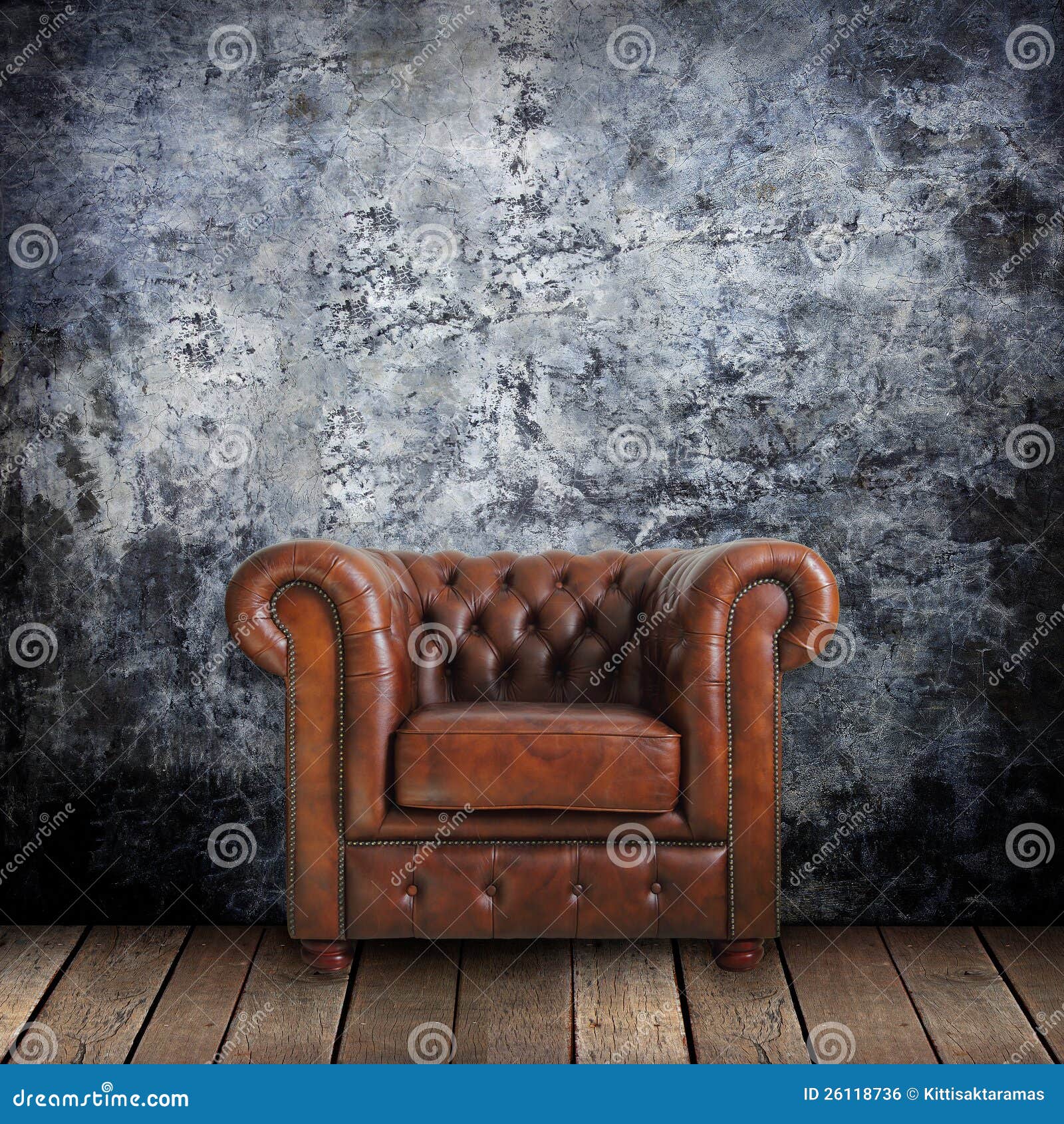 grungy wall with classic brown leather armchair and old wood