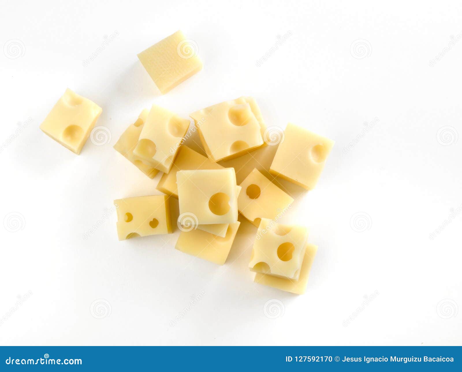 gruyere cheese cubes seen from above on a white table