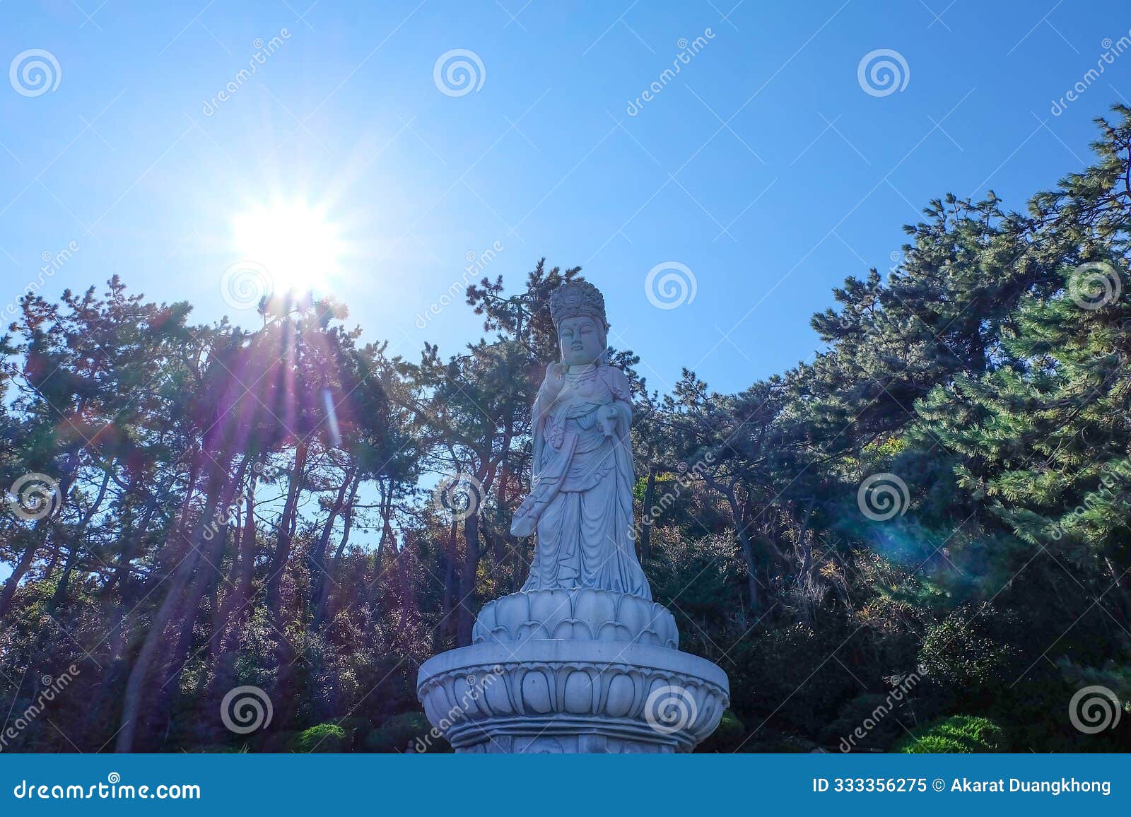 guanyin or guan yin goddess of mercy white stone statue on the top of the hill at haedong yonggungsa templ